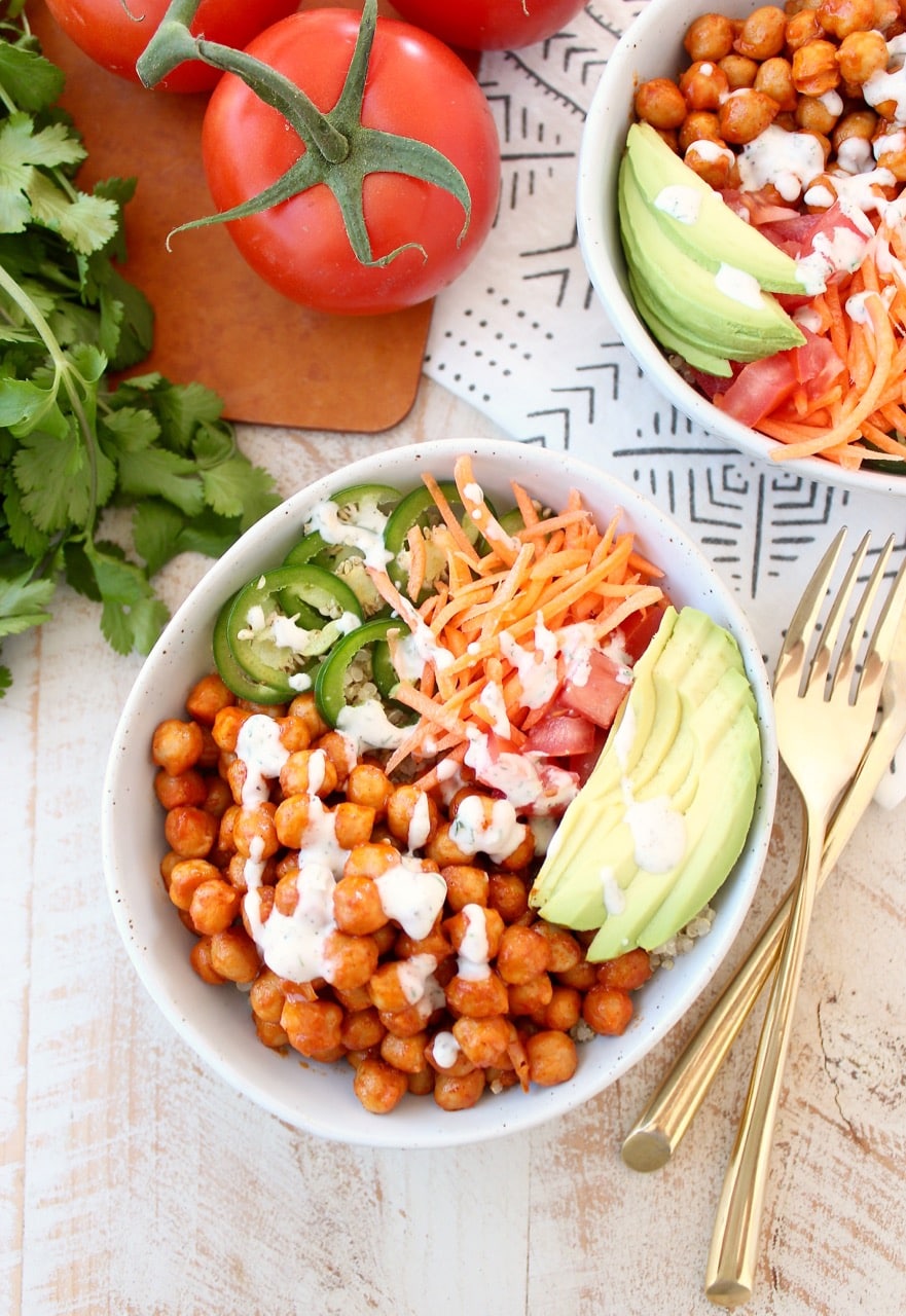 Buffalo chickpeas, quinoa and veggies are tossed together in this healthy, gluten free, vegan buddha bowl recipe, topped with an easy homemade vegan ranch dressing, all made in just 20 minutes!