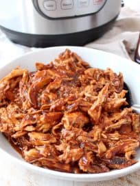 Instant Pot BBQ Chicken is easy to make with chicken breasts, directly from the freezer or refrigerator, plus a bottle of your favorite BBQ sauce. Use it to make different recipes throughout the week, from pasta for dinner, to wraps for lunch!