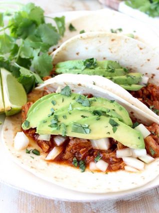 Instant pot pulled pork tacos are easy to make in under an hour with lean pork tenderloin, a delicious combination of spices and a sriracha honey tomato sauce!