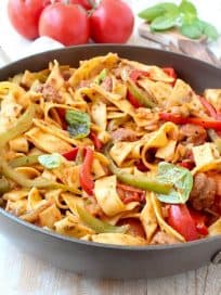 Italian Drunken Noodles with Peppers and Basil in Skillet