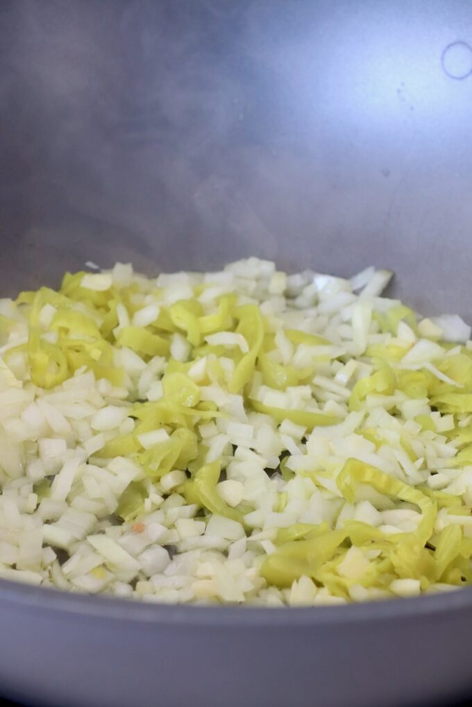 diced onions and sliced pepperoncinis in large pan