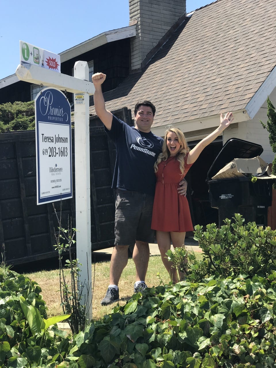 Homeowners Celebrating in front of house