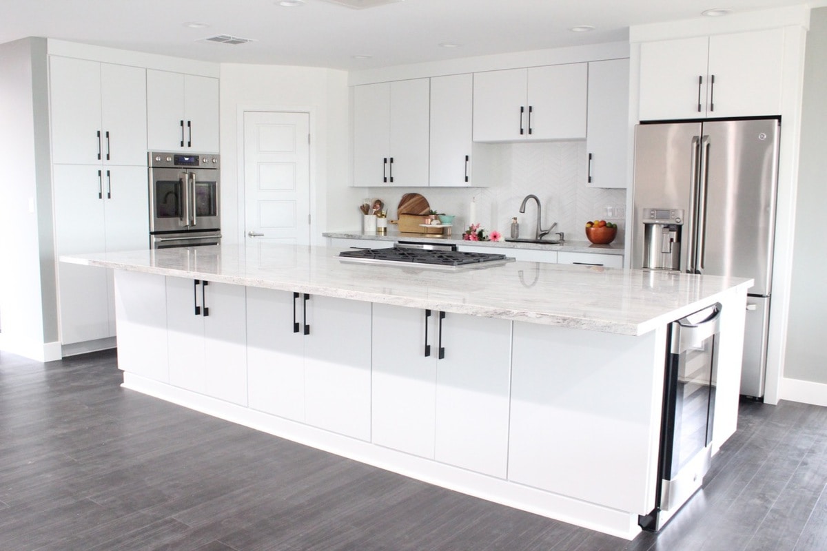 Kitchen Remodel with White Kitchen Cabinets are large 12 foot island with granite countertops