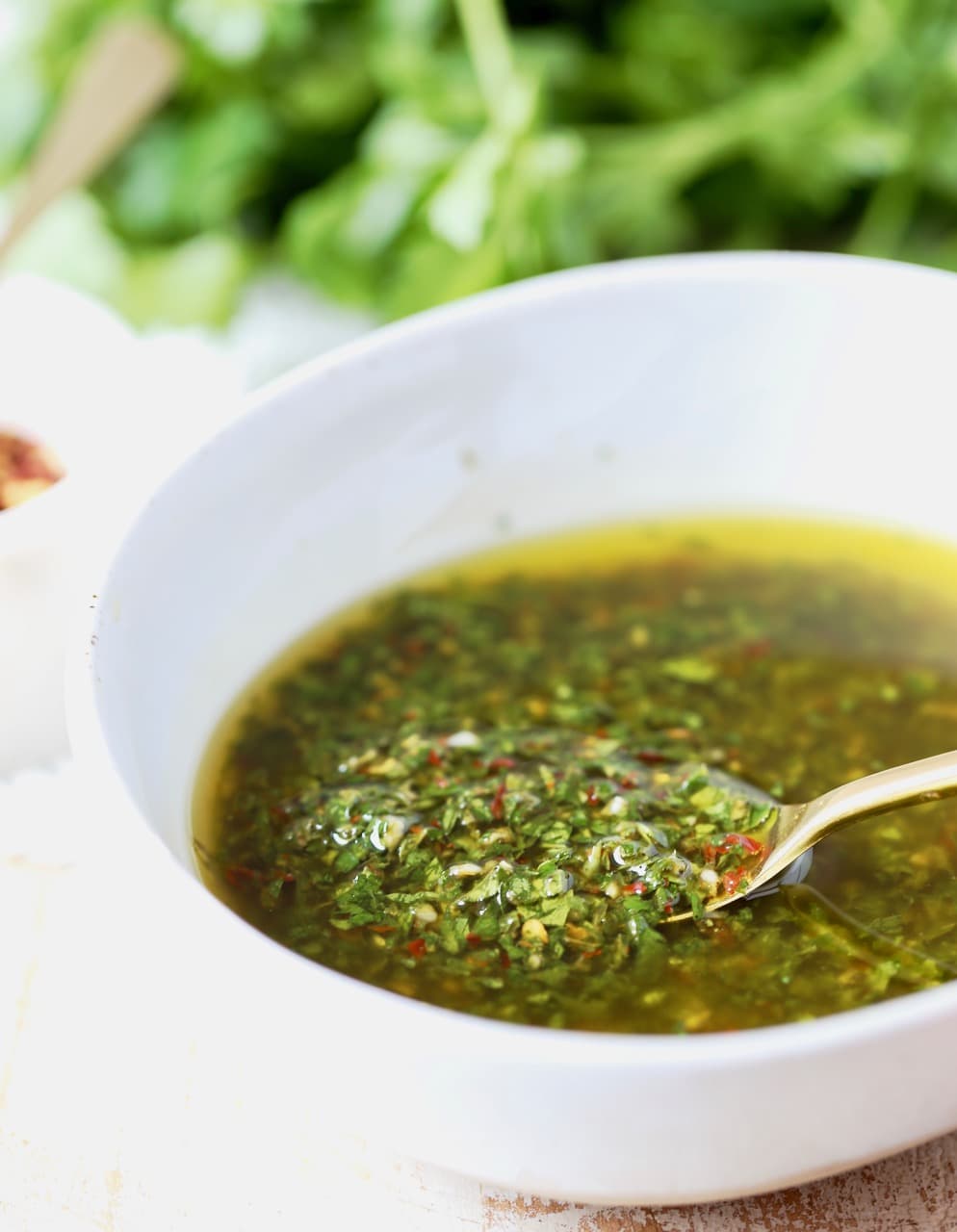 chimichurri sauce in bowl with a spoon