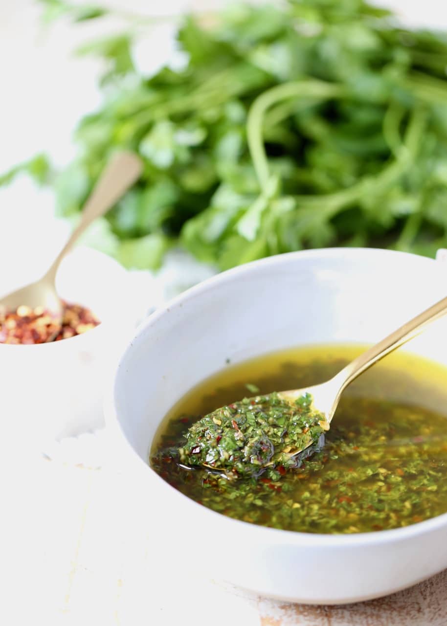 Just 8 simple ingredients are combined in 5 minutes to make this authentic and easy chimichurri sauce, perfect for topping grilled steak, chicken, shrimp or veggies!