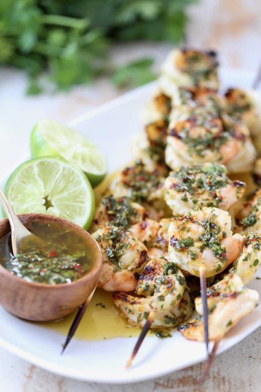 Chimichurri Shrimp Skewers with Small Bowl of Chimichurri Sauce and Limes