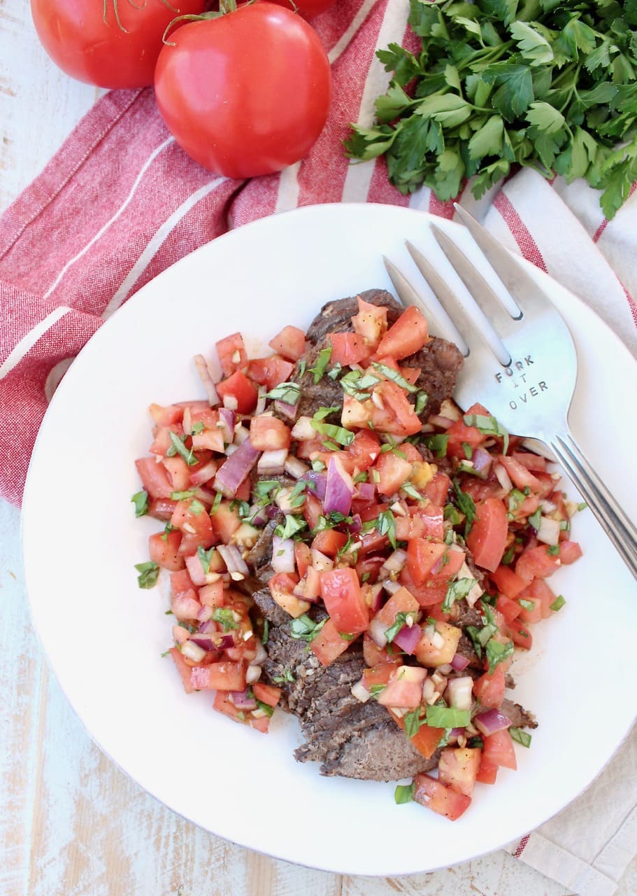 Instant Pot Beef sliced and topped with Tomato Basil Bruschetta