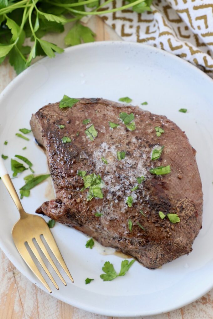 cooked steak on plate with fork