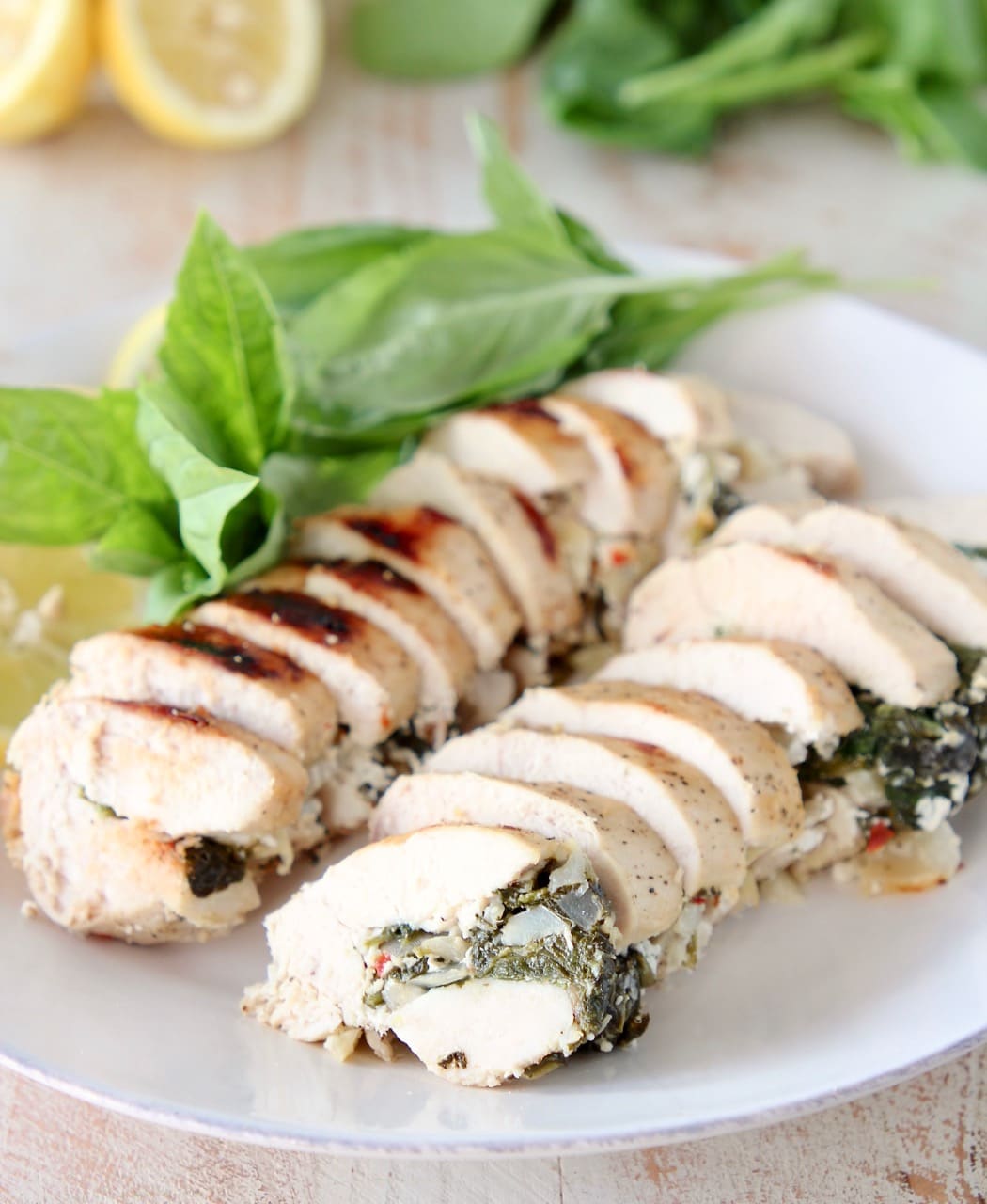 Sliced Spinach Artichoke Chicken with Fresh Basil and Lemons