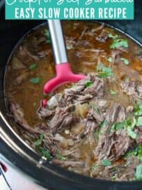 Shredded beef in slow cooker with spoon