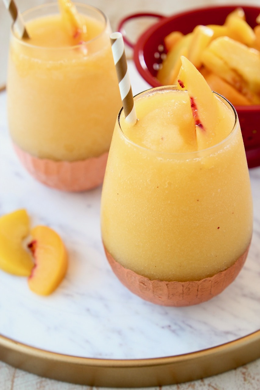 Frozen Peach Sangria on Copper Tray with Fresh Peaches