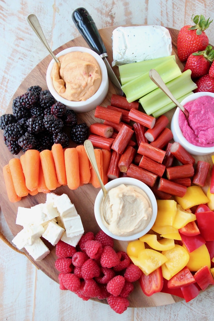 Low Calorie Charcuterie Board with Carrots, Celery, Bell Peppers, Hummus, Berries and Chicken Snack Sticks