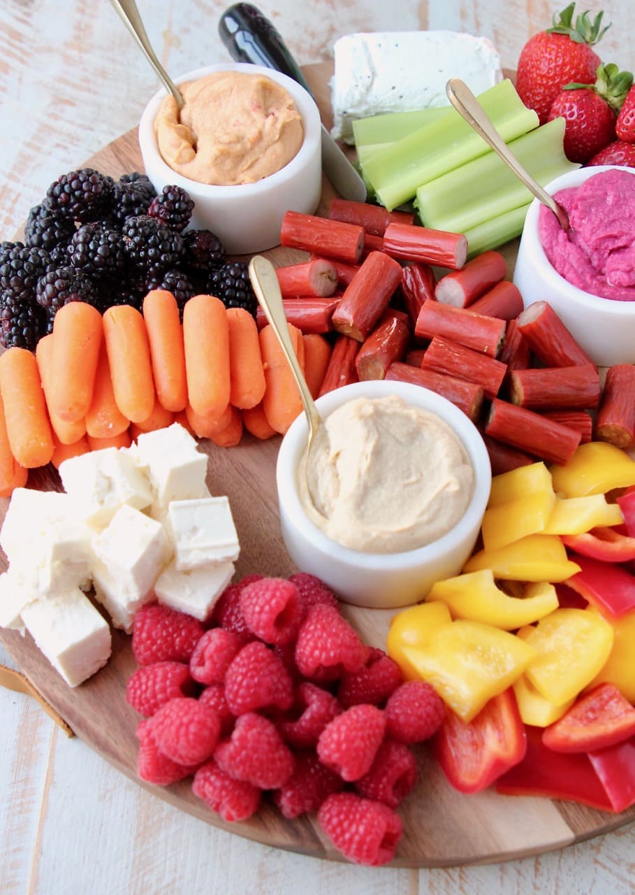 Low Calorie Charcuterie Board with Hummus, Veggies, Fruits, Cheeses and Chicken Snack Sticks