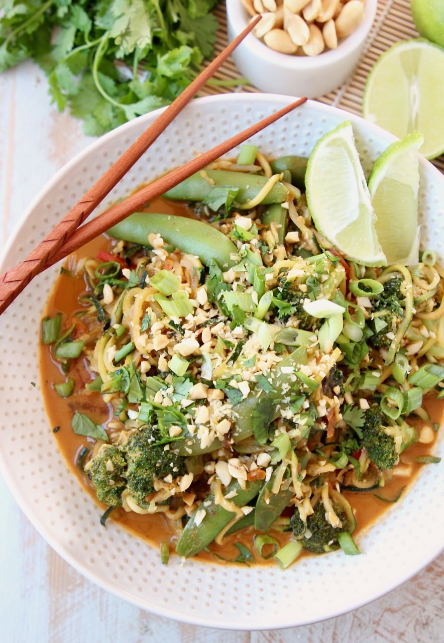 Vegan Pad Thai Recipe with Fresh Scallions, Limes, Broccoli and Cilantro in bowl with chopsticks