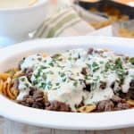 Frito Cheesesteak Pie with ground beef and creamy provolone sauce in casserole dish