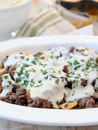 Frito Cheesesteak Pie with ground beef and creamy provolone sauce in casserole dish