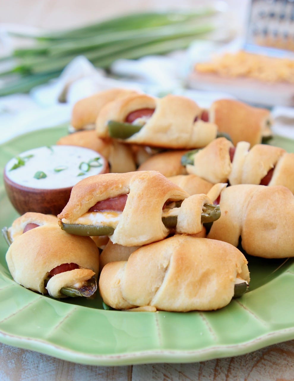 Jalapeno Popper Pigs in a Blanket on a Green Plate with Ranch Dressing