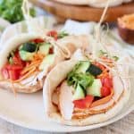 Turkey pita wrap with cucumber, cilantro, carrots and bell peppers