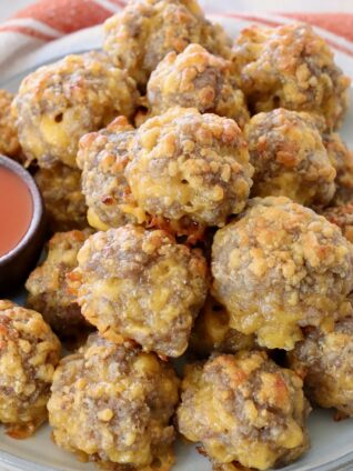 cooked sausage balls stacked up on plate