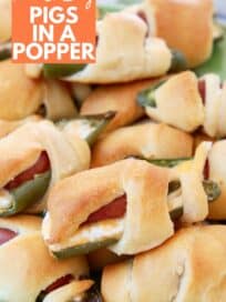 jalapeno popper pigs in a blanket on green plate