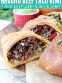 Crescent roll wrapped ground beef taco ring on wood serving board