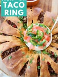 Overhead image of crescent roll wrapped ground beef taco ring on wood serving board