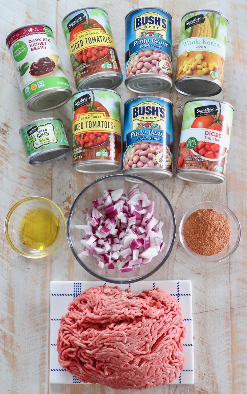 ingredients for taco soup on a white wood board