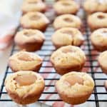 Mini Pumpkin Cookies filled with Salted Caramel on wire baking rack with orange striped towel