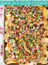 Overhead image of nachos on baking sheet topped with sliced jalapenos and onions