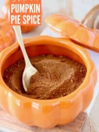 pumpkin pie spice in orange bowl with gold spoon
