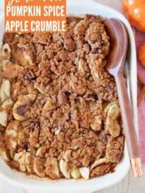 Overhead image of apple crumble in baking dish with wooden spoon
