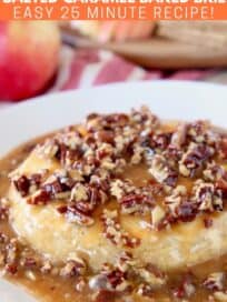 Baked brie on plate covered in salted caramel sauce and pecans