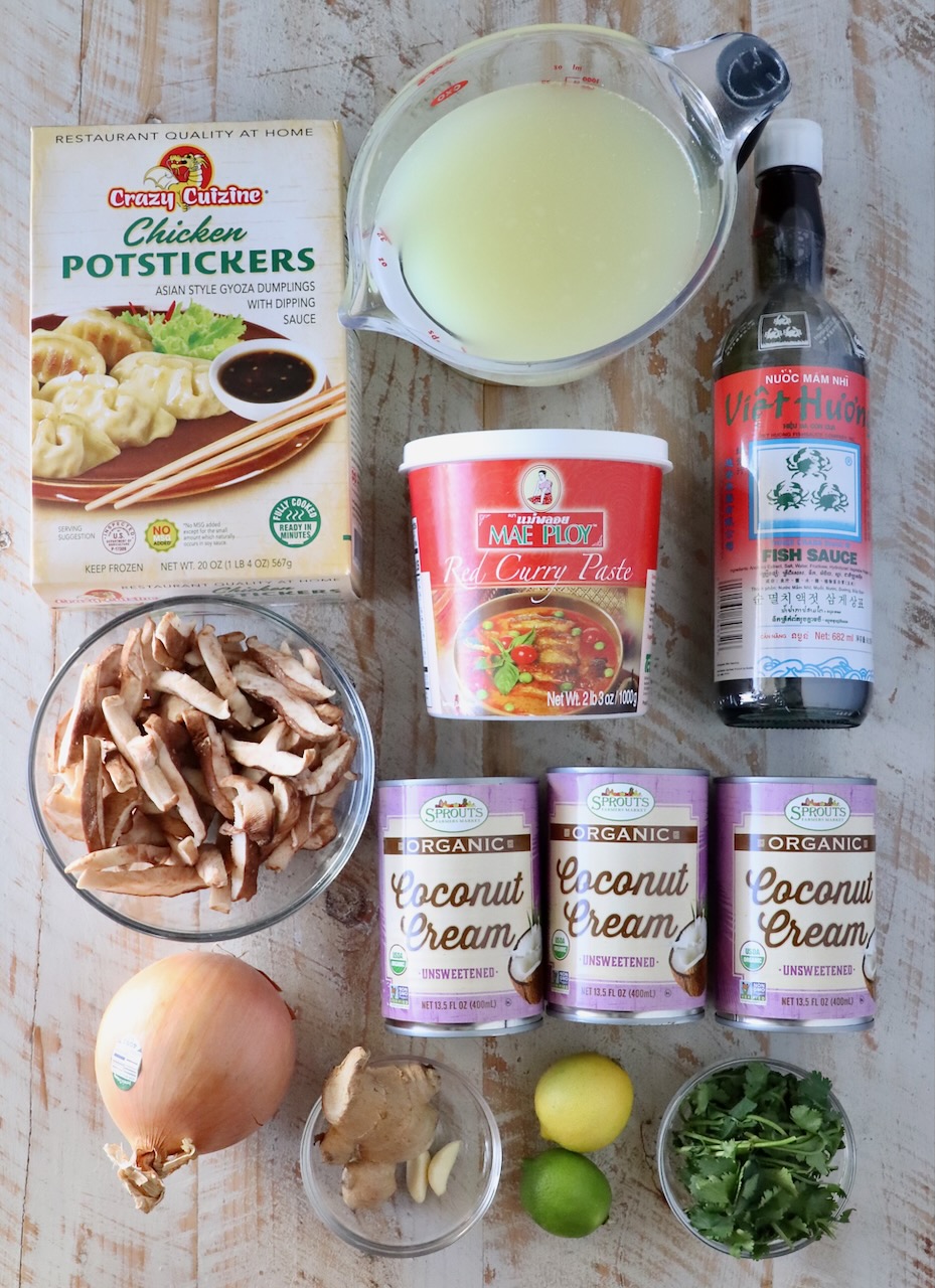 ingredients for Thai coconut potsticker soup on white wood board