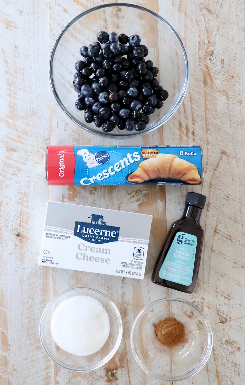 ingredients for blueberry pastries on white wood board