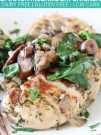 Sliced chicken breast on plate topped with sliced mushrooms and spinach