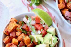 Sweet potatoes, avocado, pico de gallo and lime wedge in bowl, image with text overlay "Mexican Sweet Potato Quinoa Bowls, easy, vegan, gluten free"