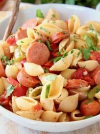 Cajun pasta with sausage in bowl with copper fork