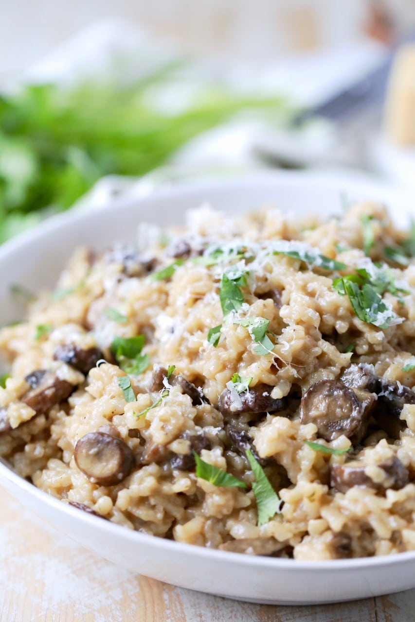 Instant pot risotto with mushrooms and parmesan cheese in bowl with spoon
