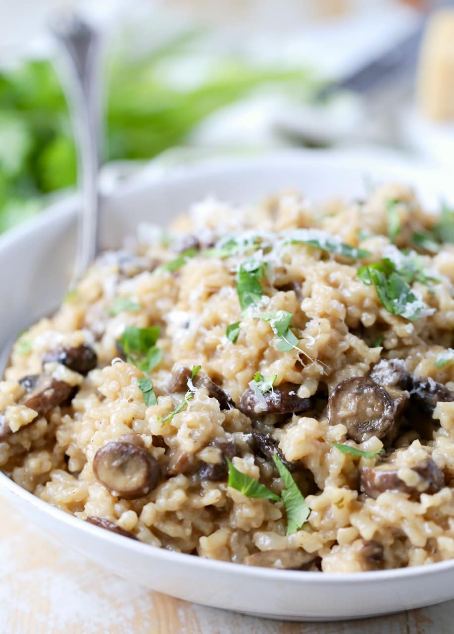 Mushroom risotto in bowl with large spoon