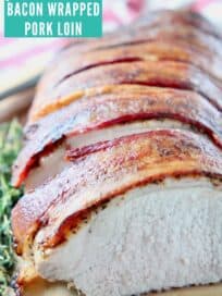 Sliced bacon wrapped pork loin on wood cutting board