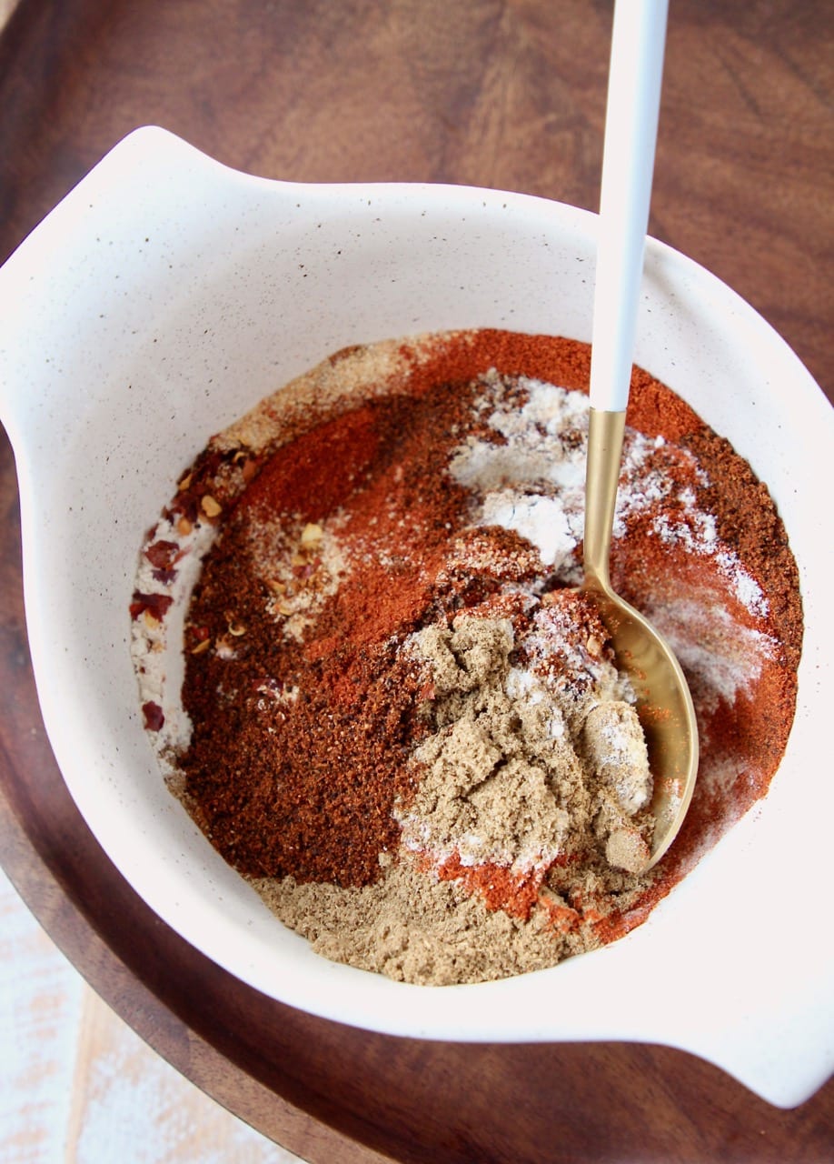 mix of spices in a bowl with a white and gold spoon