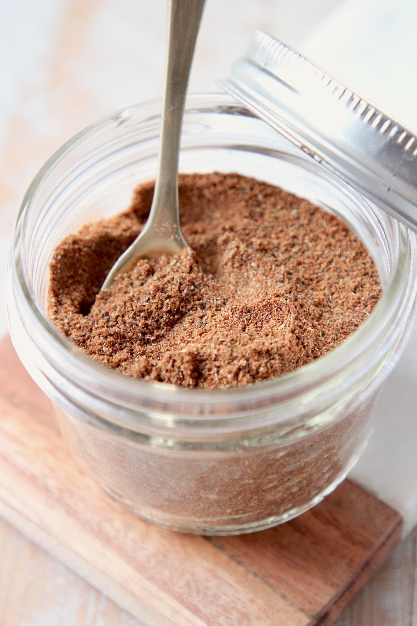 Chili seasoning in mason jar with small gold spoon