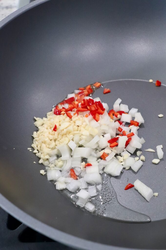 diced onions, garlic and chilies in large wok