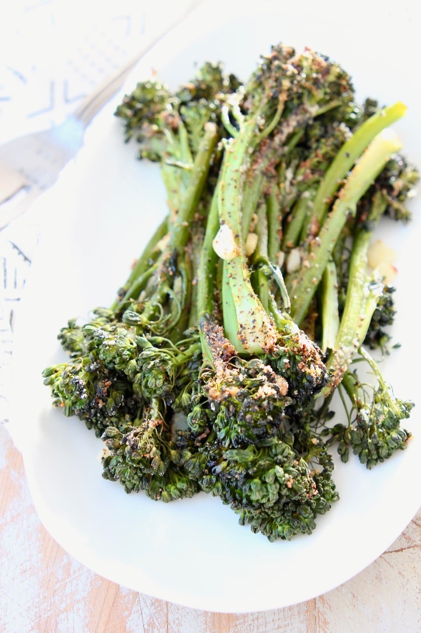 Roasted broccolini on white plate