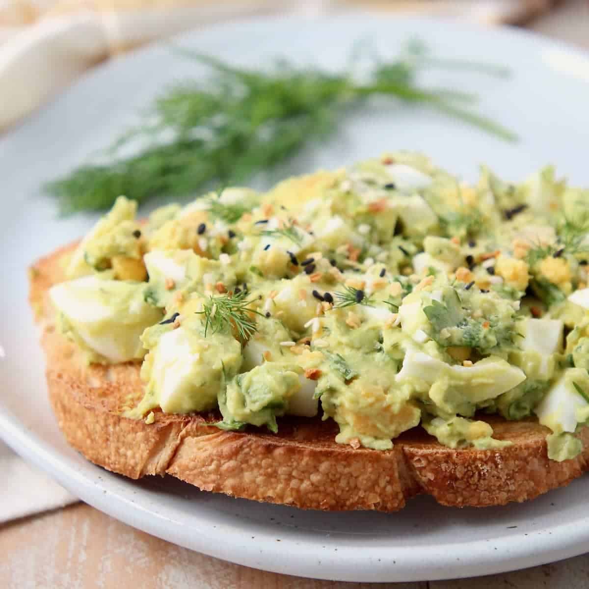 Egg salad on toast topped with everything bagel seasoning and fresh dill