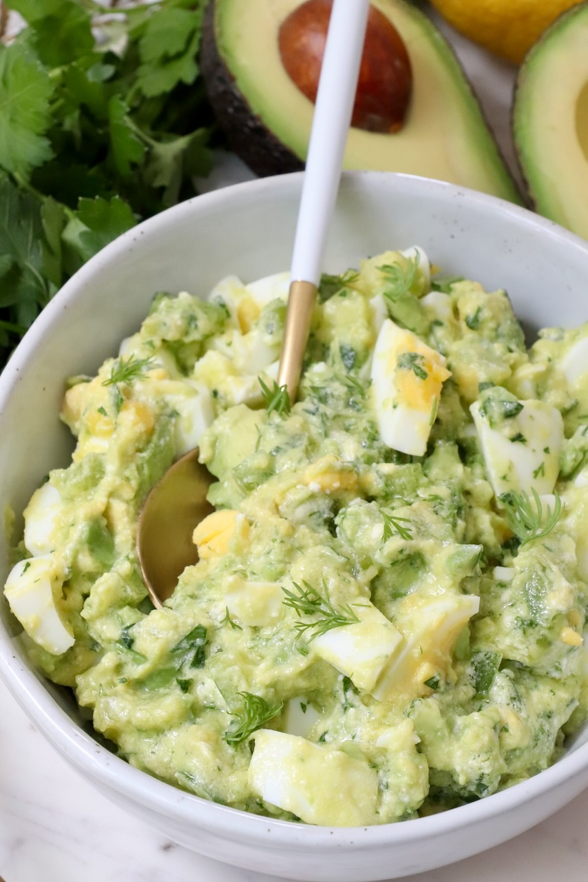 avocado egg salad in a bowl with a spoon