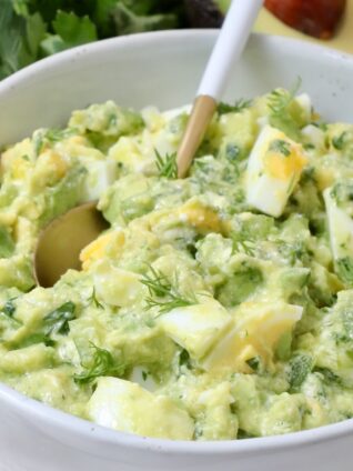 avocado egg salad in a bowl with a spoon