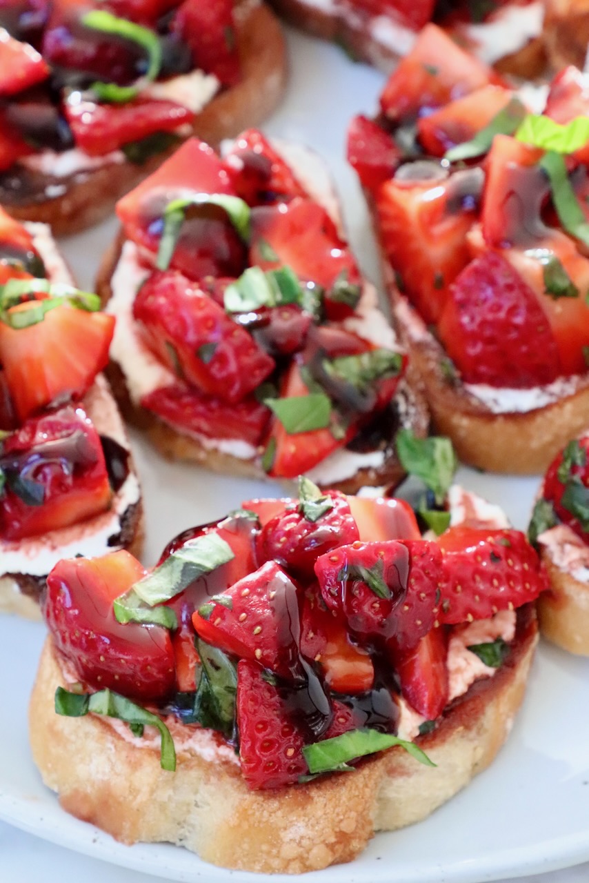 strawberry bruschetta on toasted baguette slices on a plate