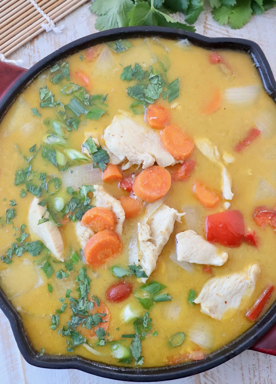 chicken and vegetables in yellow curry sauce in skillet