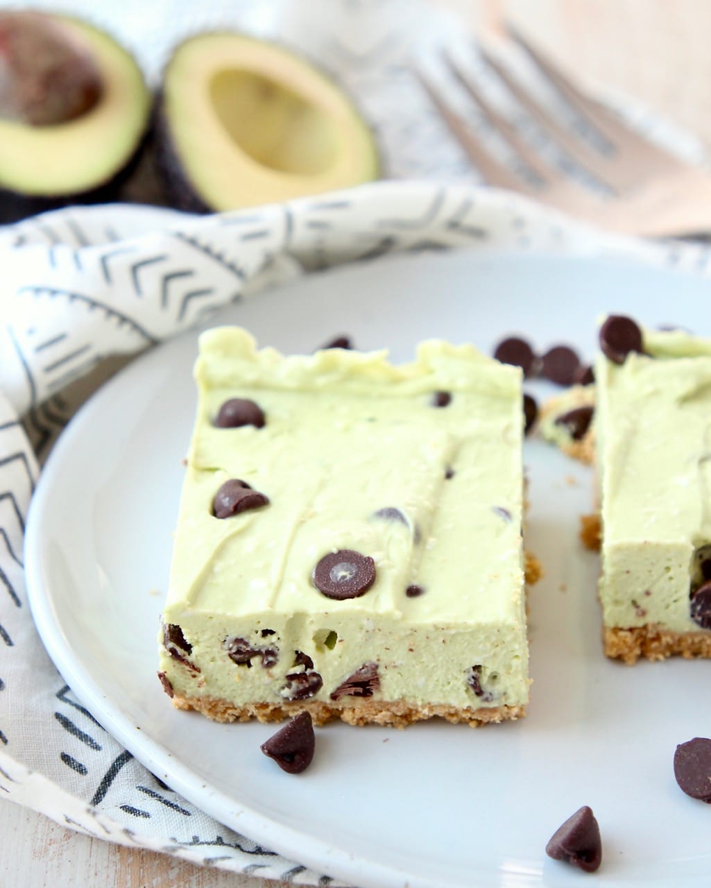 Avocado no bake cheesecake bars with chocolate chips on a plate